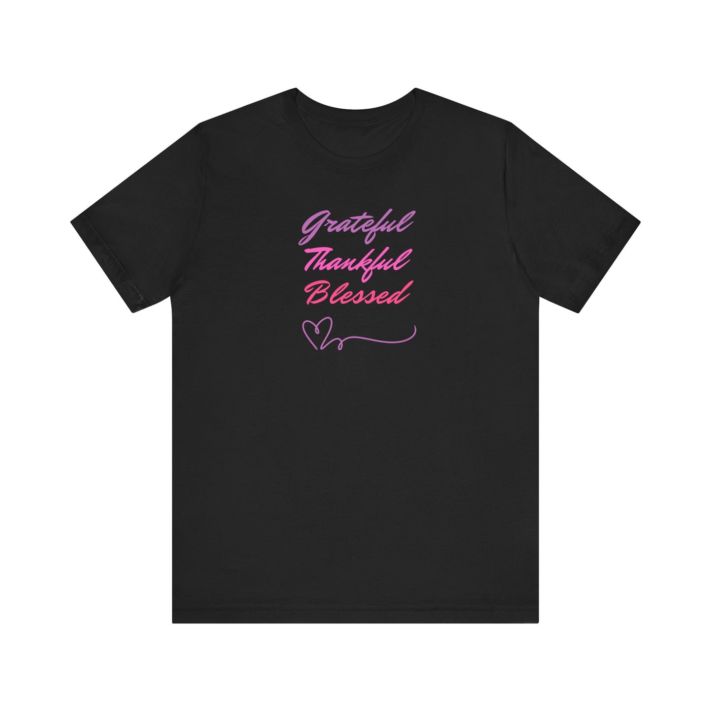 A black t-shirt with the words "Grateful," "Thankful," and "Blessed" printed in a gradient of pink and purple. Two small heart symbols are drawn below the words.