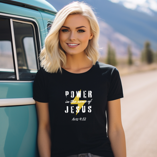 A photo of a woman wearing a black t-shirt with the text "POWER in the name of JESUS" printed in white, along with a yellow lightning bolt graphic and the Bible reference Acts 4:12.